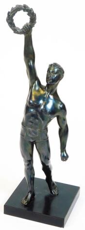 A 20thC Art Deco style spelter figure, of a Greek athlete in standing pose with arm aloft, holding garland, on square base, 35cm H.