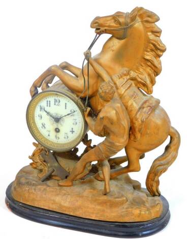 A 19thC spelter and gilt metal mantel clock, set with rearing horse and figure to his side, on a rock work base, with 10cm Dia. enamel dial with keywind movement on ebonised stand, 41cm H.