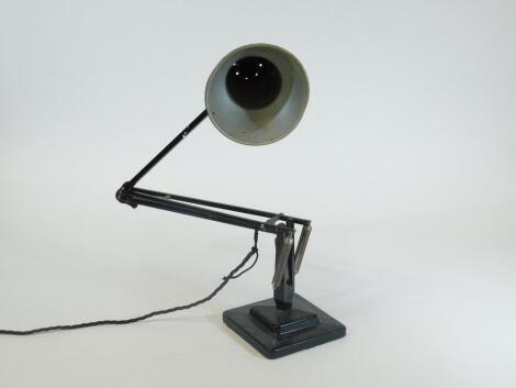 A vintage Bauhaus style angle poise lamp, in black with cone shaped shade, on a square base, 15cm x 15cm.