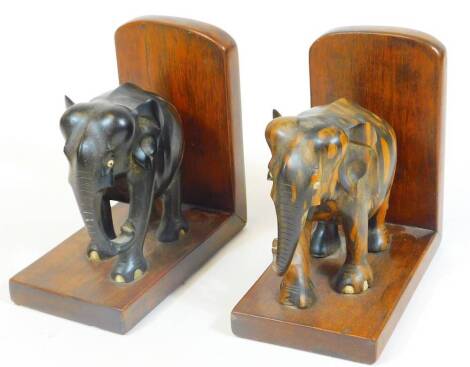 A pair of elephant bookends, on L shaped stands, tiger wood finish, 18cm H.