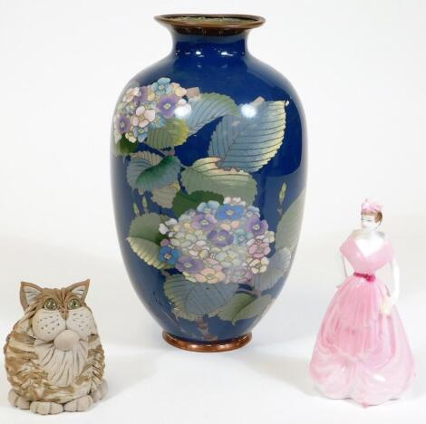 An early 20thC enamel vase, of shouldered form decorated with flowers on a blue ground, 26cm H (AF), a Zane boxed Studio pottery style cat and a miniature Coalport figure of a lady in outer box. (a quantity)