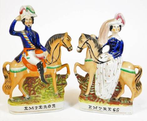 A pair of 19thC Staffordshire figures, of Emperor Napoleon 28cm H, and Empress, each polychrome decorated predominantly in blue, orange and green.