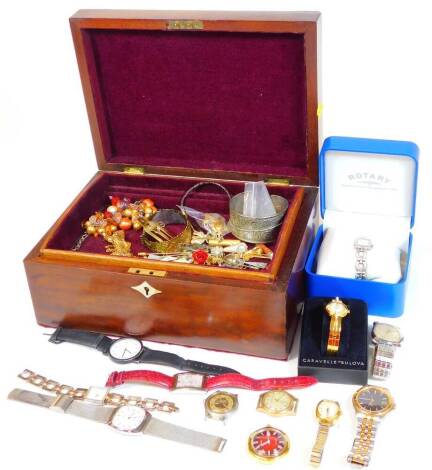 A quantity of ladies and gentleman's modern wristwatches, some costume jewellery, brooches, torque bangles, silver drop earrings, gold plated chains, etc. all in a mahogany writing box. (1 box)