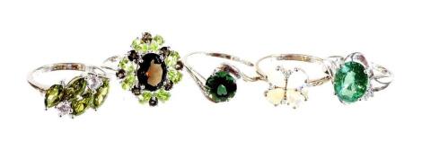 Five silver dress rings, each stone set with green, brown and white coloured stones, of varying design. (5)