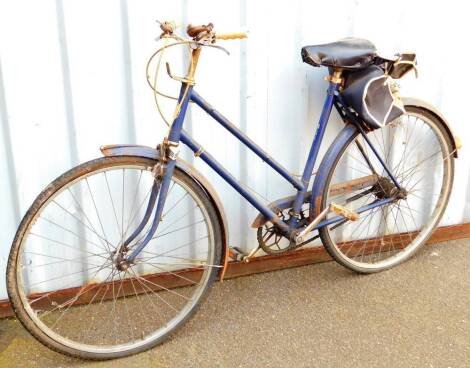 A vintage BSA ladies bicycle, with leather saddle, stapled bell and three gears, 100cm H.