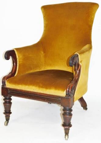 A 19thC mahogany library chair, with inverted back and shaped seat upholstered in (later) gold material, with scroll arms and turned front legs terminating in castors, 112cm H.