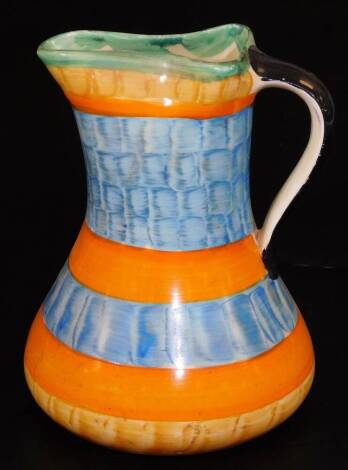 A mid 20thC Myott & Sons pottery jug, of shaped form, decorated with a stripe pattern predominately in orange, blue, yellow and green, printed marks beneath, 19cm H.