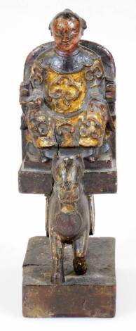 A Chinese carved and gilt lacquered wood figure, of a dignitary on horse mounted palanquin, on block base, probably Ming dynasty, 21cm H..