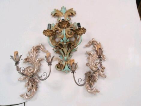 A garniture of three Italian carved wooden wall sconces with metal mounts