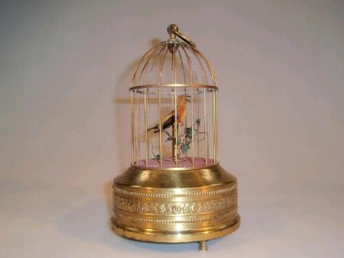 A gilt metal automaton bird in a cage