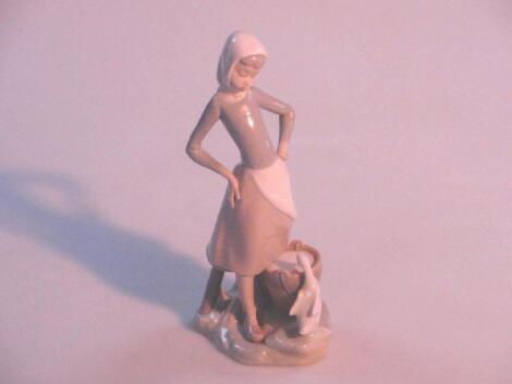 A Lladro figure of a country girl with a duck and water bucket