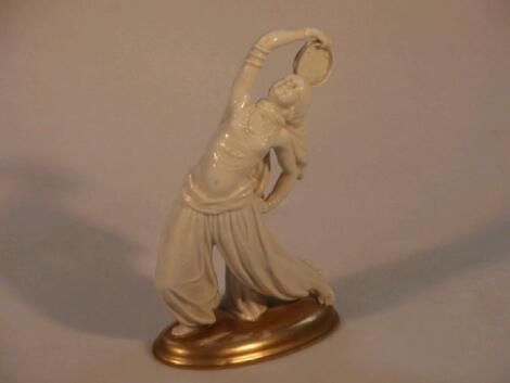 A Sitzendorf ivory glaze figure of a Middle Eastern belly dancer