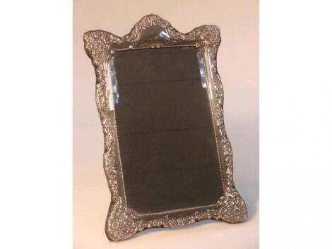 A modern silver framed easel mirror