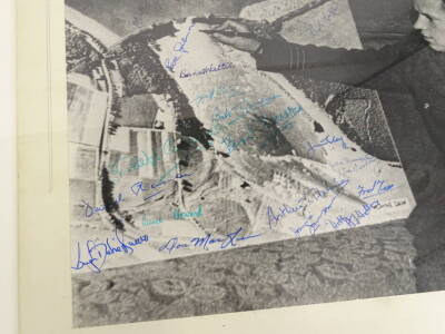 A photograph of Guy Gibson about to sign a chart for The Mohne Dam Raid, with many signatures including Eve Gibson, Mick Martin, Arthur T Harris, Johnnie Johnson, Bob Burford etc. 28cm X 38cm and a photographic print of The Mohne Ram and signatures. (2) - 2