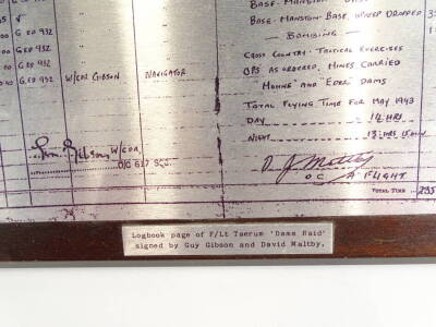 A printed stainless steel plaque depicting the log book page of Flight Lieutenant Taerum, of the "Dams Raid" signed by Guy Gibson and David Maltby, 19cm x 25cm, plus title plaque on an easel frame. - 2