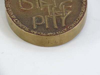 A bronze plaque or paperweight, dedicated to the war poet Wilfred Owen (1893-1918), cast with a poppy to one side, the reverse stating The Poetry is in the Pity, with various notes to the border. - 3