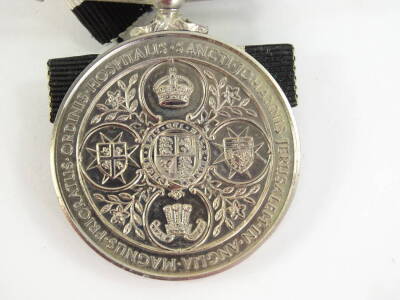 A St John's Ambulance Brigade medal, cast with Queen Victoria in profile and with the motto to the reverse, sold with a medallion awarded to Irene Graves, badges, etc., and a album of autographs relating to Irene Graves, containing various poems, small s - 2