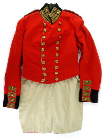 A George V period red military dress coat, with knot shoulder boards, black upright collar and black cuffs, gilt metal regimental buttons to front, collar and wrists, central slash to skirt, (AF).