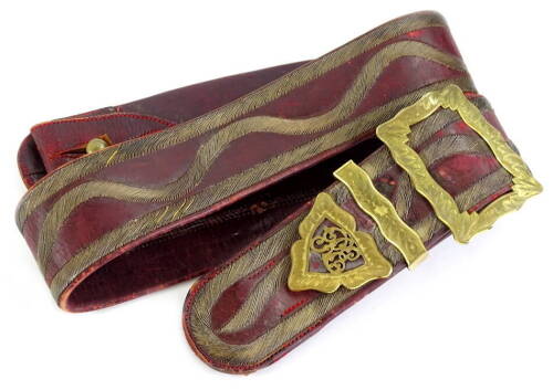 A Royal Engineer's sash, in red Moroccan leather with gilt buckle and RE badge, probably 19thC, bearing paper label to interior with ink inscription (indecipherable).