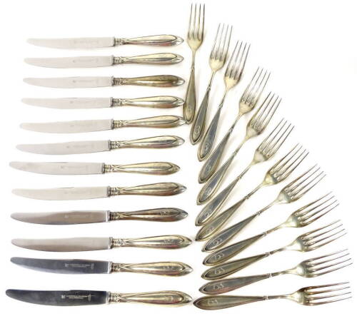 A set of twelve early 20thC German while metal table forks, each with a tapering handle and engraved initial B. Stamped 800, makers marks for Mansfelder Silber, Dusseldorf, and a set of twelve table knives, each engraved with the initial B, handles with 8