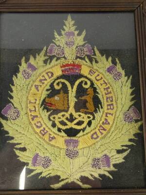 An Argyll and Sutherland regimental needlework motto sampler, 25cm x 25cm, and a cellulose memorial card, both framed. - 2