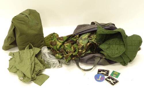 Two kits bags, together with various camouflage clothing, badges, etc.