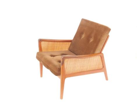 A Peter Hvidt and Olga Molgaard-Nielsen teak and cane lounge chair, circa 1950's, for France and Daverkosen, Denmark, with cushion seat and back.The upholstery in this lot does not comply with the 1988 (Fire & Fire Furnishing) Regulations, unless sold to 