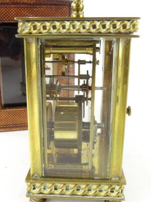 An early 20thC French carriage clock, of square form with swing handle, five part glazed case and fancy base, terminating in compressed circular feet, with a visible movement and plain back plate, single train key wind movement, in fitted case, when handl - 3