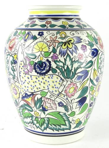 A 20thC Poole pottery Persian pattern vase, by N Blackmore, of shouldered form, polychrome decorated, predominantly in green, yellow and blue, on a circular foot, printed with marks beneath S K, 36cm high.