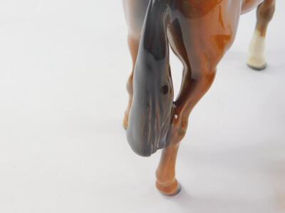 A Beswick model of a huntsman on a bay horse, 20cm H, together with a fox hound and seated fox. (3) - 4