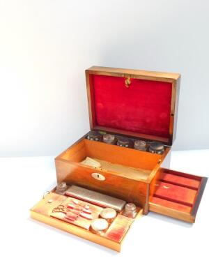 A Victorian rosewood travelling box with mother of pearl escutcheon, the hinged lid opening to reveal a fitted interior, with cut glass bottles and jars with cut glass stoppers or plated lids, together with a manicure set, to the side a semi secret drawer - 2