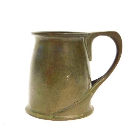 An Archibald Knox pewter tankard, no.066, possibly for Liberty and Co., with a hammered body and divided sinuous handle, impressed marks, including Solkete, 12.5cm H.