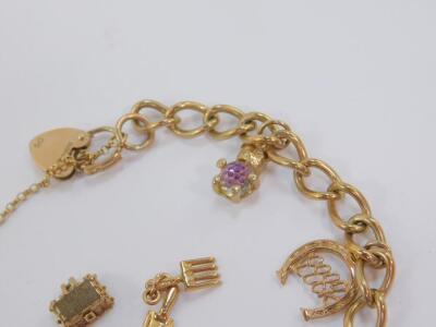 A 9ct gold charm bracelet, with five charms as fitted, on a heart shaped padlock clasp with safety chain and two further charms unfitted, 20.5g. - 3