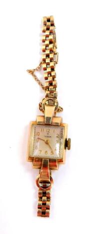 A Tudor lady's 9ct gold cased wristwatch, rectangular silvered dial bearing Arabic numerals, Swiss 17 jewel movement, in a Dennison plain rectangular case, on a 9ct gold bracelet, with safety chain as fitted, 15.5g.