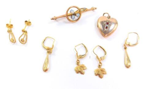 A Victorian opal and seed pearl floral bar brooch, set in yellow metal, stamped 9ct, three pairs of 9ct gold earrings, one set with small cultured pearls, 6.6g., and a heart shaped photo locket, set with a cross to the front, with seed pearls and rubies, 