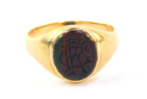 A gentleman's blood stone signet ring, monogram engraved, in yellow metal, stamped 18ct, size R, 6.0g.