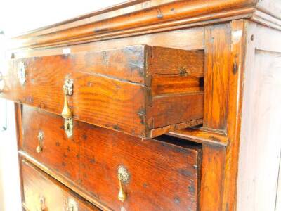 A mid 18thC oak chest on stand, the outswept pediment over four graduated drawers, the stand with three further drawers and a shaped apron, over turned columns united by a boxed stretcher, raised on bun feet, 98.5cm W, 55cm D, 165cm H. - 2