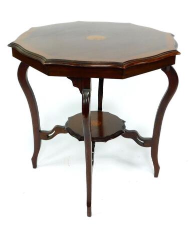 A Victorian mahogany and crossbanded occasional table, the serpentine side top with herringbone and sunburst patera inlay, raised on cabriole legs united by an undertier with four scrolling supports, 76cm Dia. 73.5cm H.