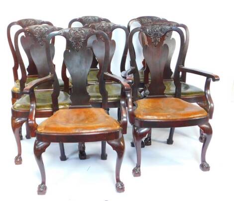A set of eight George I style mahogany dining chairs, with floral and foliate carved vase shaped splats, rounded frame with drop in leather seats, raised on cabriole legs and ball on claw feet, comprising pair of carvers and six single chairs.