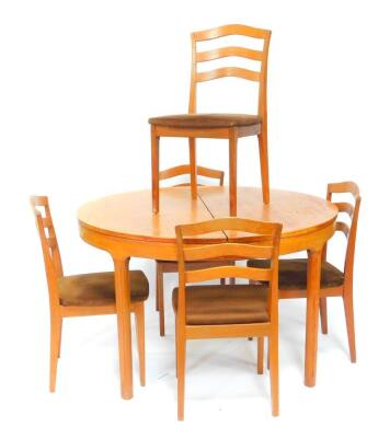 A Nathan circular teak drawer leaf dining table, with one additional leaf, raised on tapering square legs, 121cm Dia., 167cm extended, together with five single dining chairs.