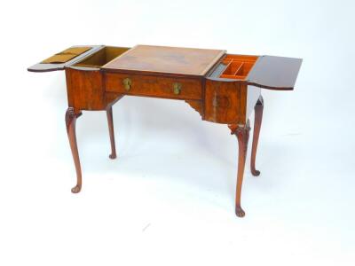 An early 20thC walnut breakfront desk, with a central square tooled leather writing surface above a single frieze drawer, flanked by two hinged bowfronted side sections, opening to reveal fitted interiors, raised on a leaf carved cabriole legs and fluted - 2