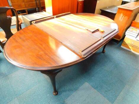 A Victorian mahogany wind out dining table, with three and half additional leaves, raised on cabriole legs on pad feet, with winder, 145cm W, 294cm extended, 117cm D, 74cm H.