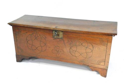 A 18thC oak blanket chest, with a later carved panelled front, raised on bracket feet, 112cm W, 39.5cm D, 50cm H.