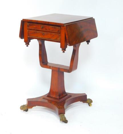 A William IV flame mahogany drop flap work table, with two fitted drawers, raised on a U shaped support and outswept square column, on a quatrefoil base with lion's paw brass capped stump feet, on castors, 37cm W, 68cm extended, 45cm D, 78cm H.