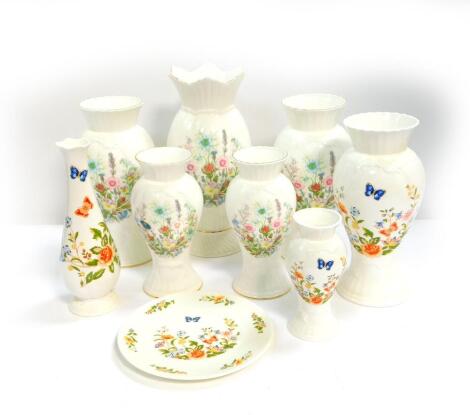 Five Aynsley porcelain vases decorated in the Wild Tudor pattern, of molded baluster form, comprising a pair and three single vases, 22-31.5cm H, three further vases decorated in the Country Garden pattern, together with a plate. (9)