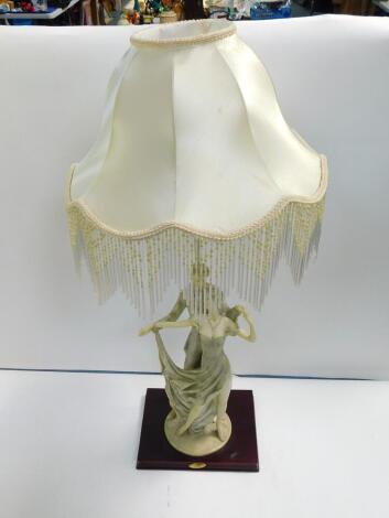 A Juliana Collection figural table lamp, modelled as a pair of dancers, raised on a rectangular wooden base with a fluted and tasseled shade, 86cm H.