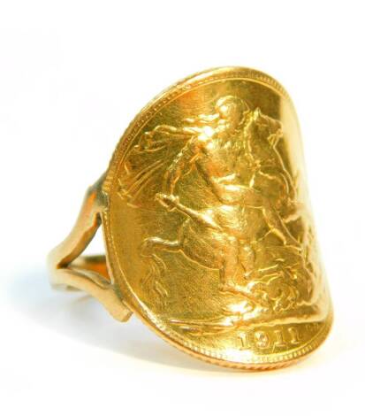A George V gold sovereign, 1911, formed into a ring with a yellow metal mount, size P, 10.0g.