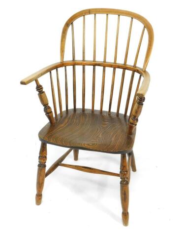 A 19thC oak and elm Windsor chair, with solid saddle seat, raised on turned legs united by an H framed stretcher, 89.5cm H, 56cm W.