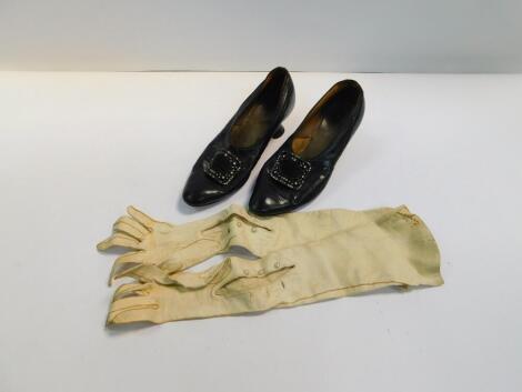 A pair of early 20thC lady's black leather shoes, with paste set buckles and a pair of lady's long kid skin gloves.