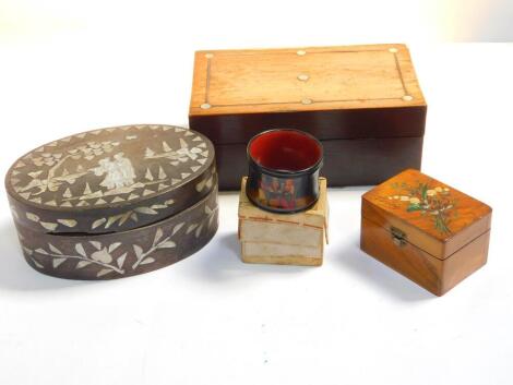 A late Victorian olive wood souvenir box for Nice, painted with spray of flowers, a Russian black lacquer handpainted napkin ring with original box, rosewood workbox and a Chinese black lacquer oval box and cover with mother of pearl inlay. (4)